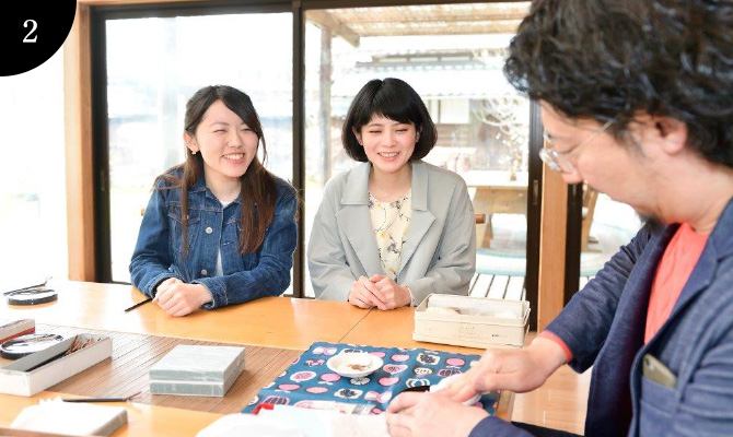 A craftsman coats lacquer over the etched ware.